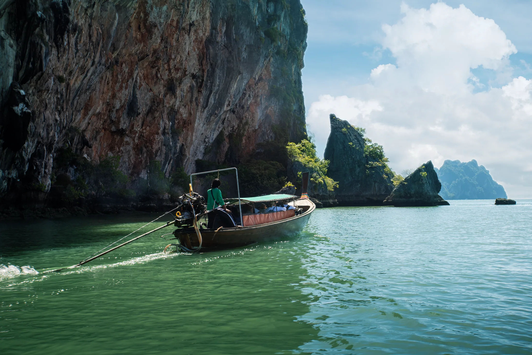 A traditional longtail boat in a turquoise Phi Phi lagoon